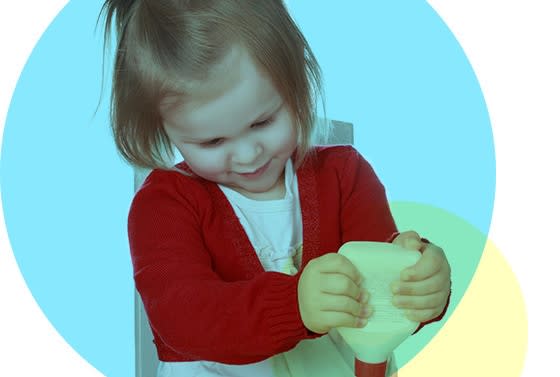 Niña aplica pegamento que esta en un tarro blanco